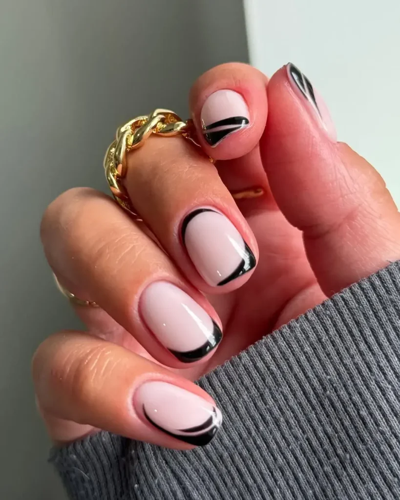 curved or asymmetric black french tip nail designs