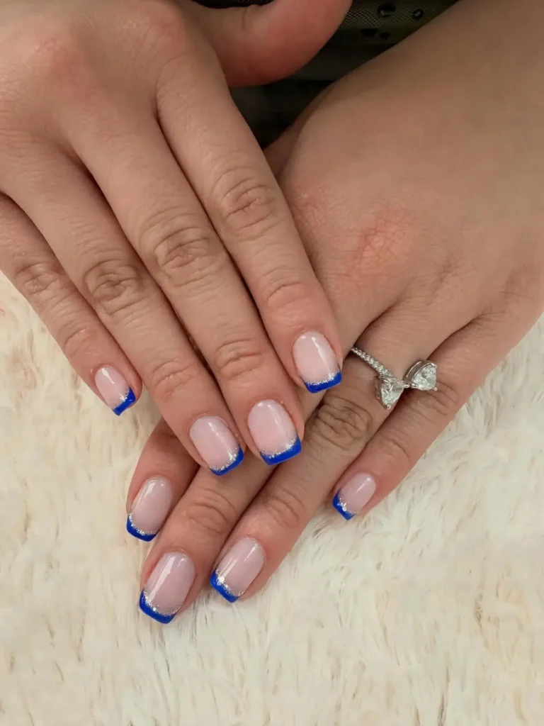 glitter-outlined blue french tip nails