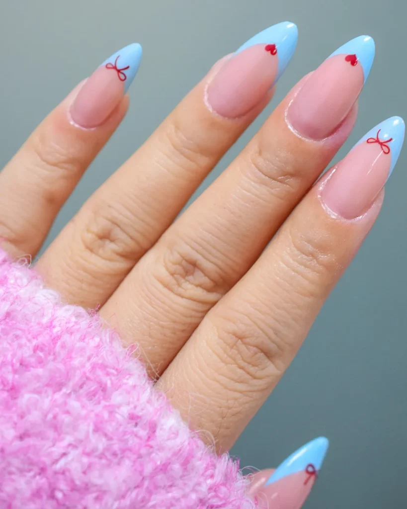hearts, bows, and coquette details blue finish french tip nails