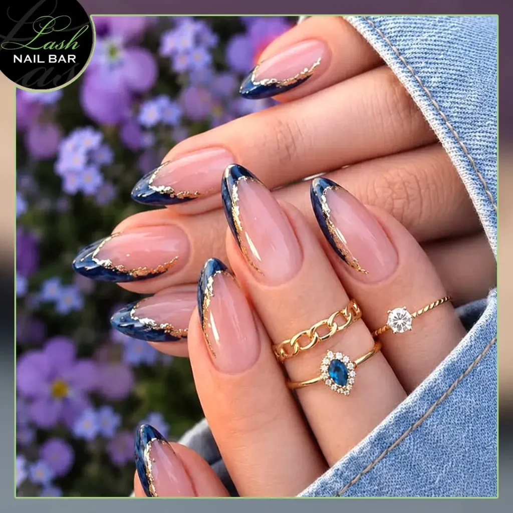 navy with gold foil or pearl detail french tip nails