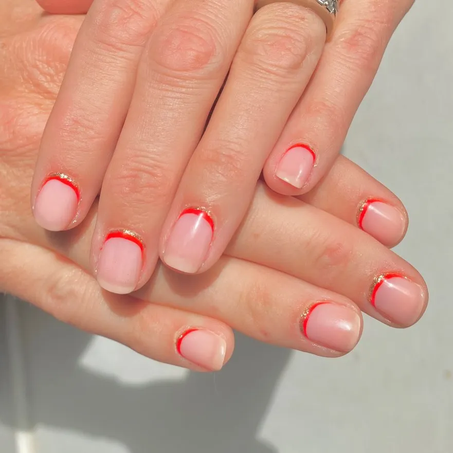reverse red french tip nude nails