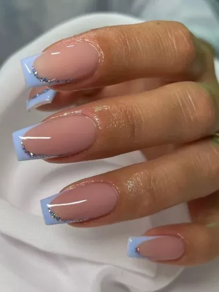 sky blue with rhinestones or studs french tip nails
