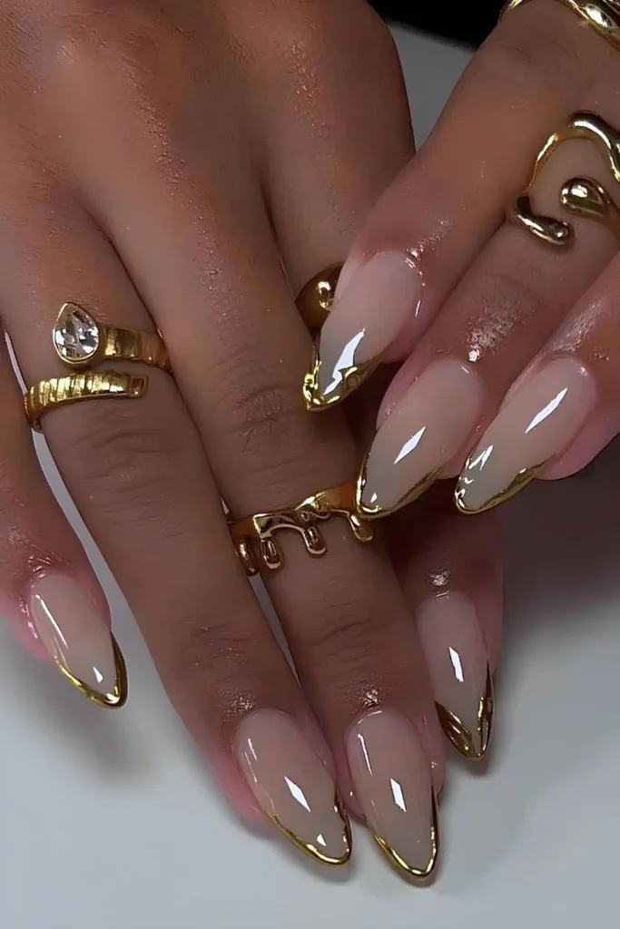 Chrome French Tip Nails 2026: 32 Designs and What to Tell Your Nail Tech 32 3d gold chrome molten drip tips on long almond nails with a nude base