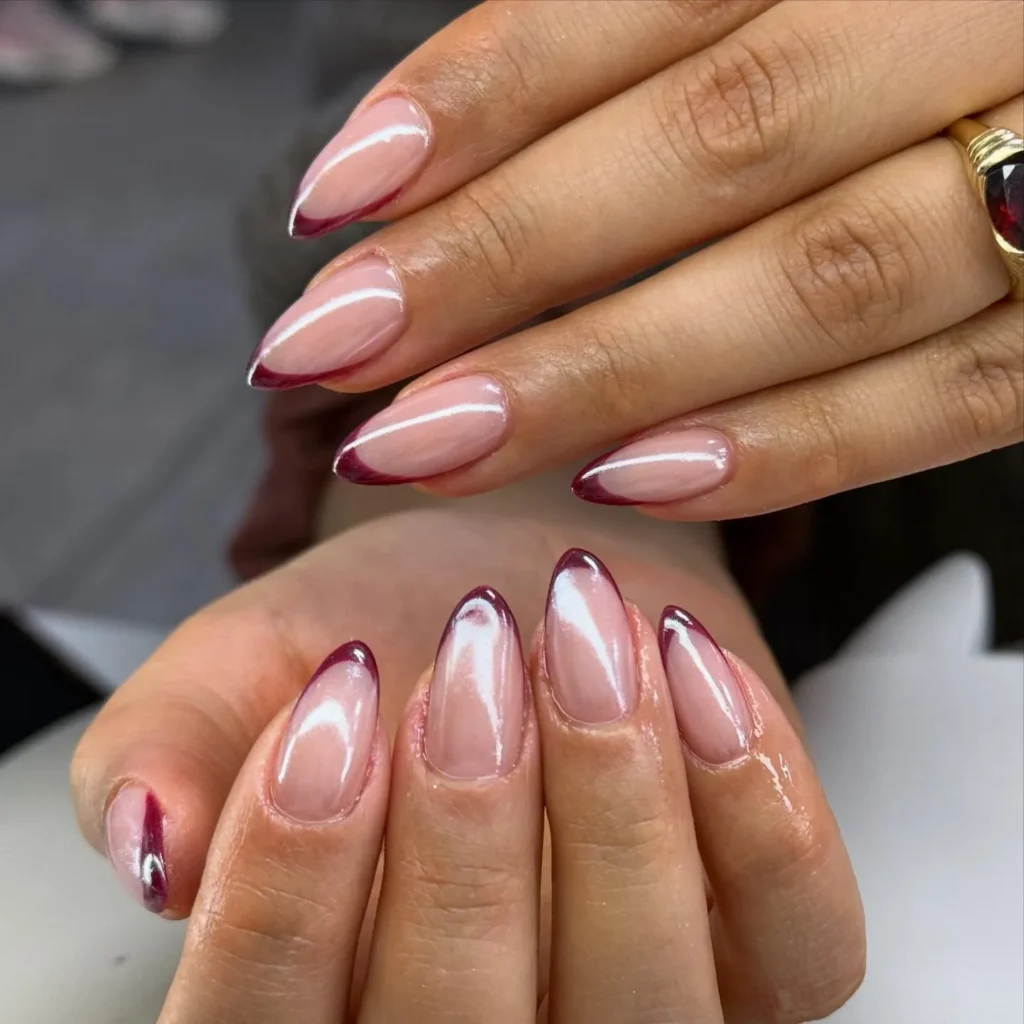 Chrome French Tip Nails 2026: 32 Designs and What to Tell Your Nail Tech 19 burgundy chrome french tips on almond nails with a sheer pink base