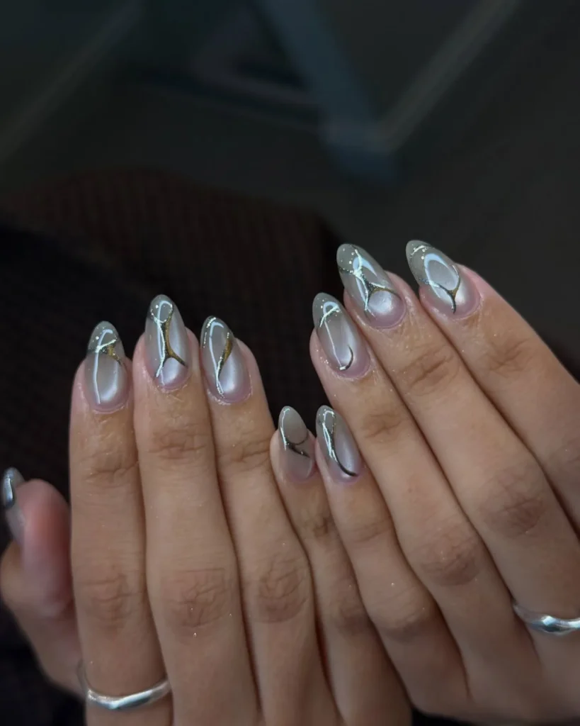 Chrome French Tip Nails 2026: 32 Designs and What to Tell Your Nail Tech 33 cat eye gel nails with silver chrome tips and a light band across the nail on almond shape