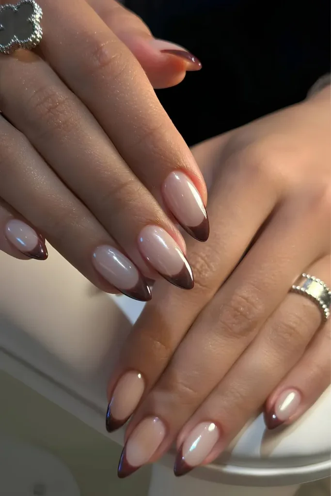 Chrome French Tip Nails 2026: 32 Designs and What to Tell Your Nail Tech 20 chocolate brown chrome french tips on short oval nails with a nude base