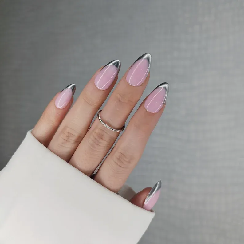 Chrome French Tip Nails 2026: 32 Designs and What to Tell Your Nail Tech 5 Gunmetal gray chrome tips fading into a soft pink base on almond nails