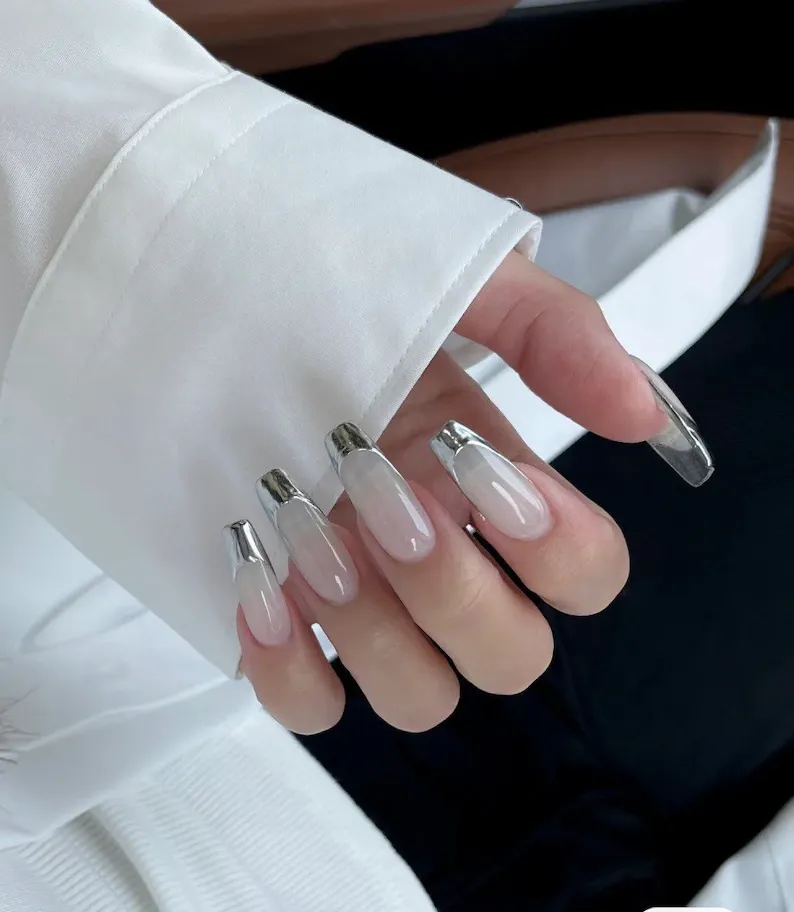 Chrome French Tip Nails 2026: 32 Designs and What to Tell Your Nail Tech 4 Mirror silver chrome tips on long coffin nails over a milky white base