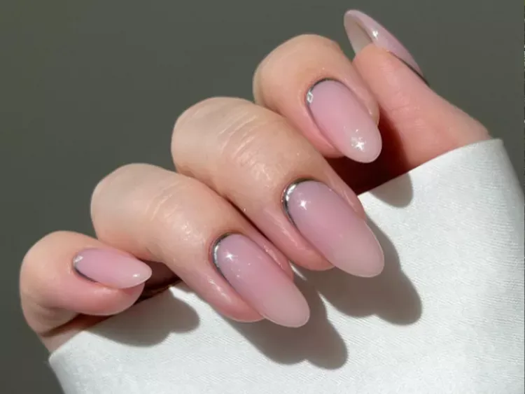 Chrome French Tip Nails 2026: 32 Designs and What to Tell Your Nail Tech 30 reverse chrome french manicure with a thin silver curve at the cuticle on oval nails
