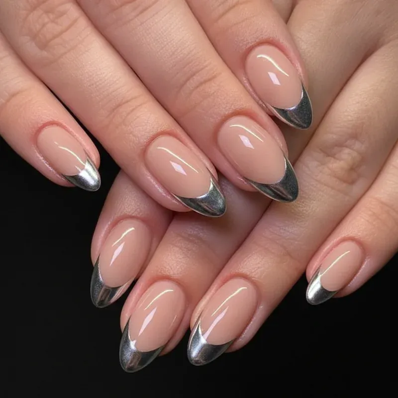 Chrome French Tip Nails 2026: 32 Designs and What to Tell Your Nail Tech 3 Thin silver chrome French tips on almond nails with a sheer pink base