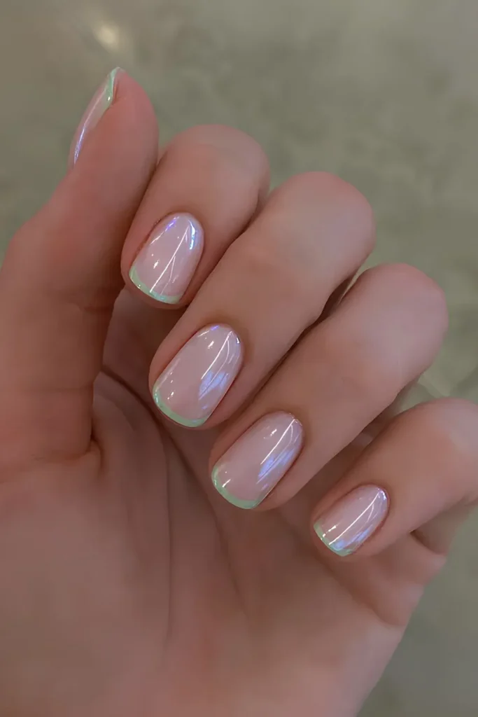 Chrome French Tip Nails 2026: 32 Designs and What to Tell Your Nail Tech 8 vanilla chrome french tips on short square nails with a sheer nude base