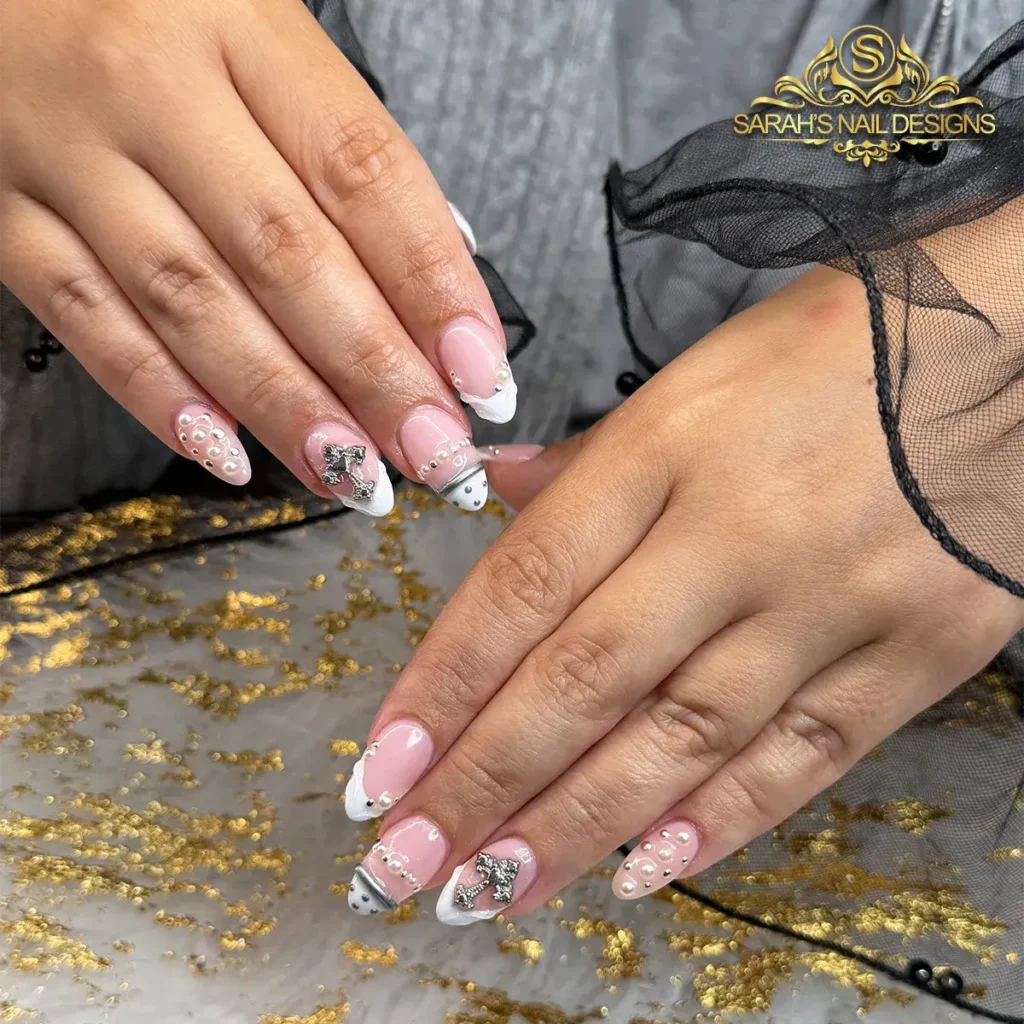 Chrome French Tip Nails 2026: 32 Designs and What to Tell Your Nail Tech 34 vanilla chrome french tips with tiny pearls and a small silver bow on almond nails